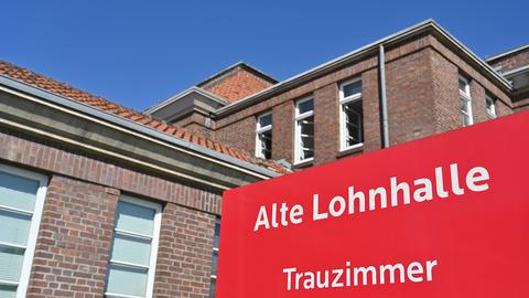 Ein Schild weist auf den Eingang des Trauzimmers der Alten Lohnhalle in Bochum-Wattenscheid hin.